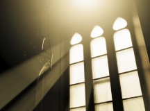 Rays of light through glass in a window church