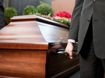 Dolor - Funeral with coffin on a cemetery, the casket carried by coffin bearer