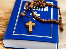 Holy Bible with wooden crucifix and rosary